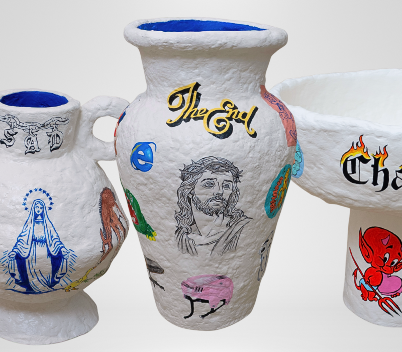 Three hand-built paper clay objects, each hand-painted in a whimsical, nostalgic style. The pieces feature playful 90s childhood references, surreal imagery, and layered textures, blending memory, storytelling, and sculptural form in a tactile, collectible set.