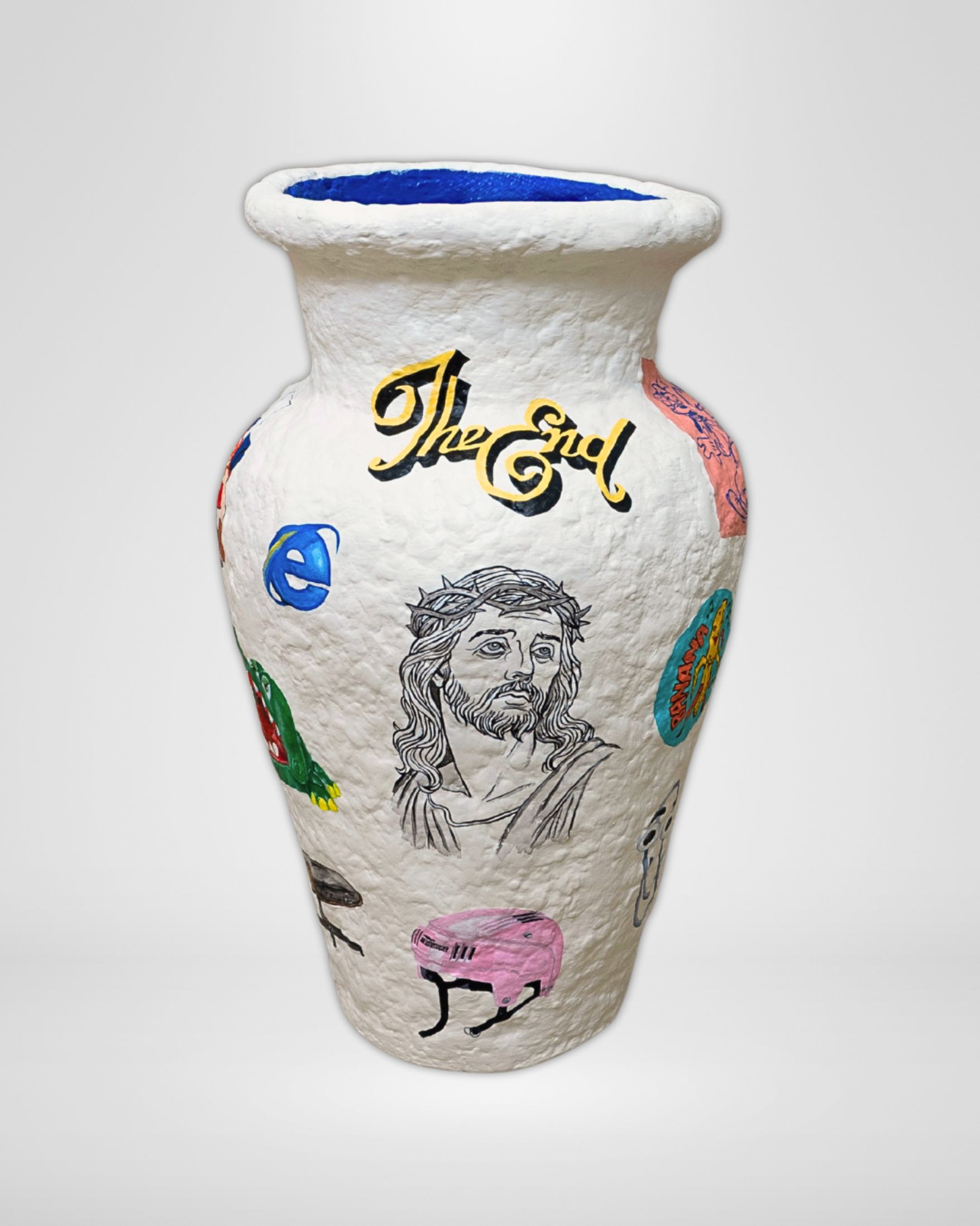 The Rapture Vase, a hand-built paper pulp sculptural vase, hand-painted with nostalgic 90s imagery including a Pizza Hut Land Before Time puppet, Alligator Dentist game, stackhat helmet, and subtle digital icons like Clippy and the Explorer symbol, capturing childhood wonder, play, and tactile, immersive storytelling.