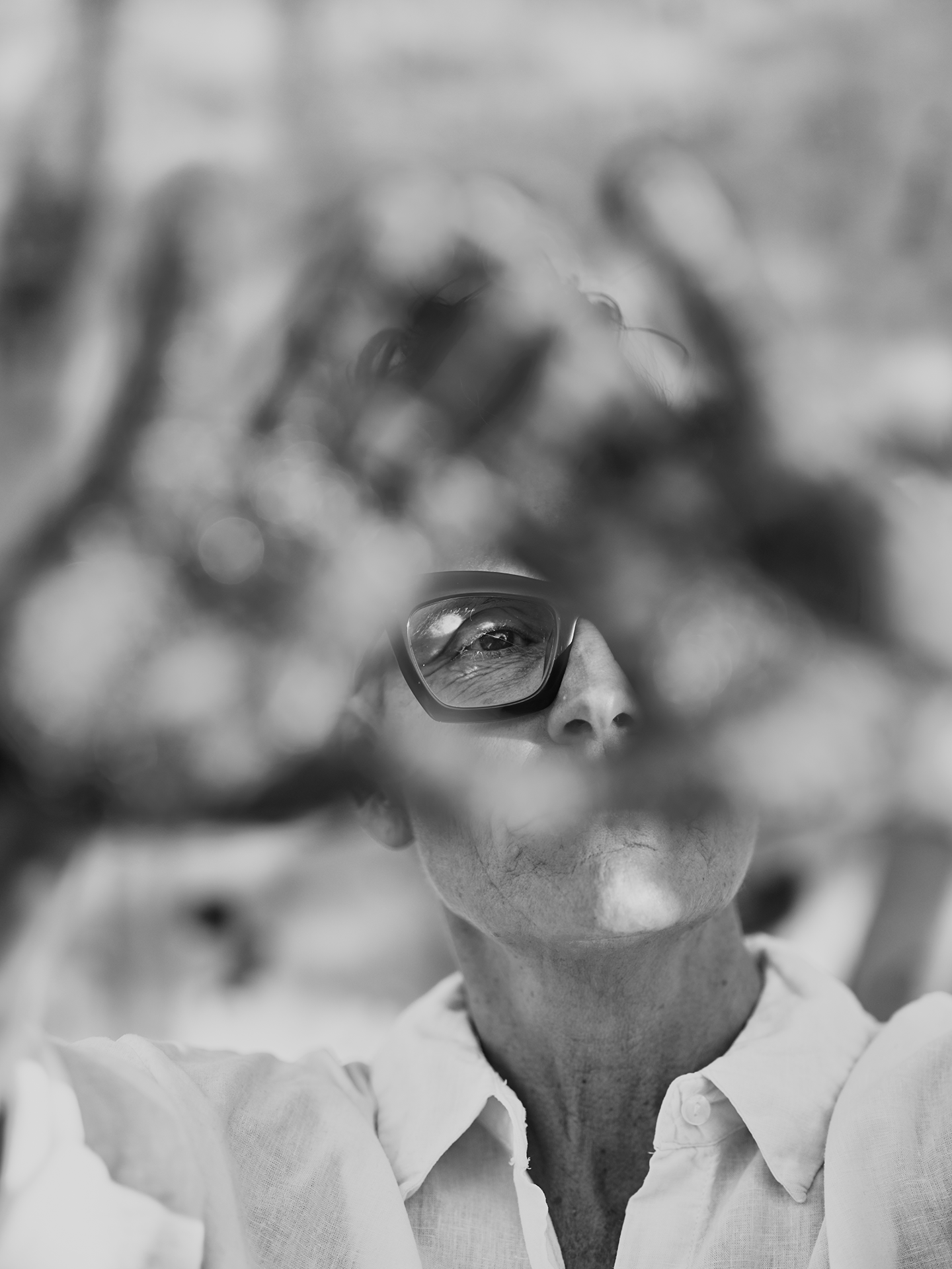 portrait of artist Deborah White with hands in front of her face